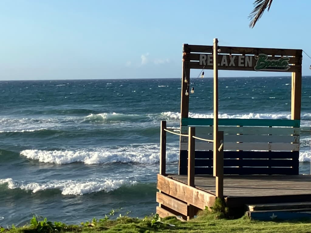 Outdoor seating with food and drinks near the beach