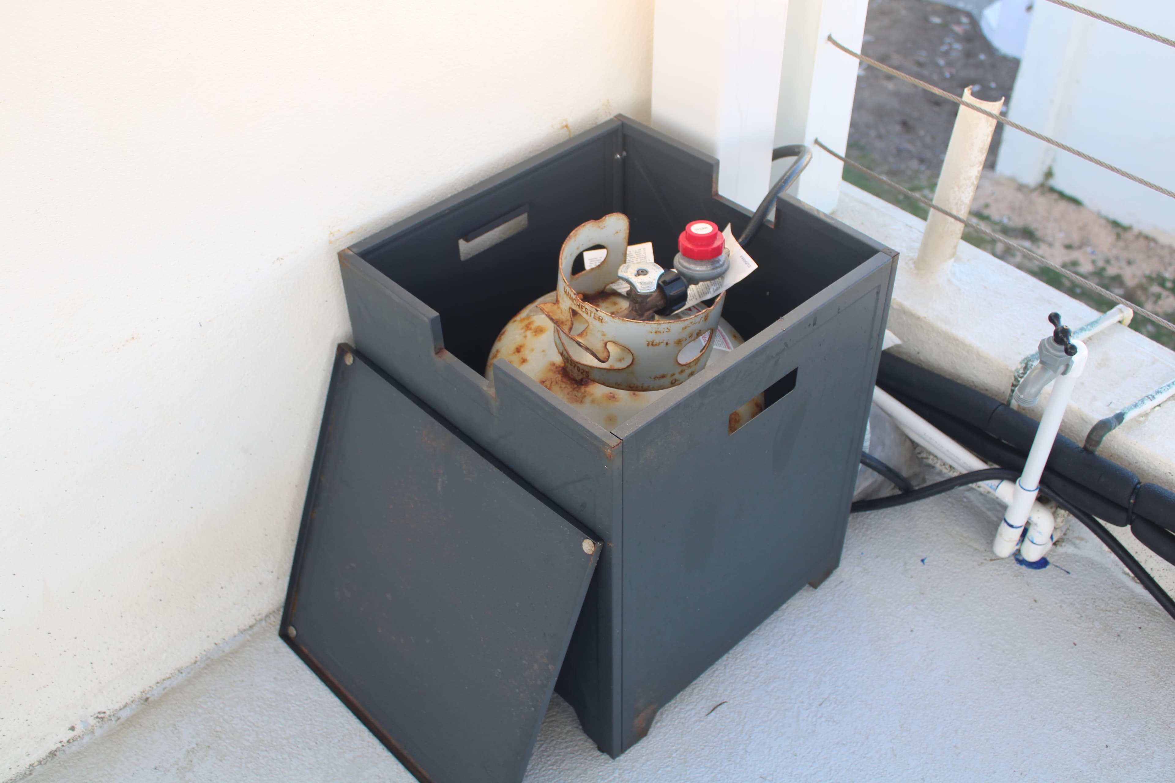 Propane tank inside the metal storage enclosure