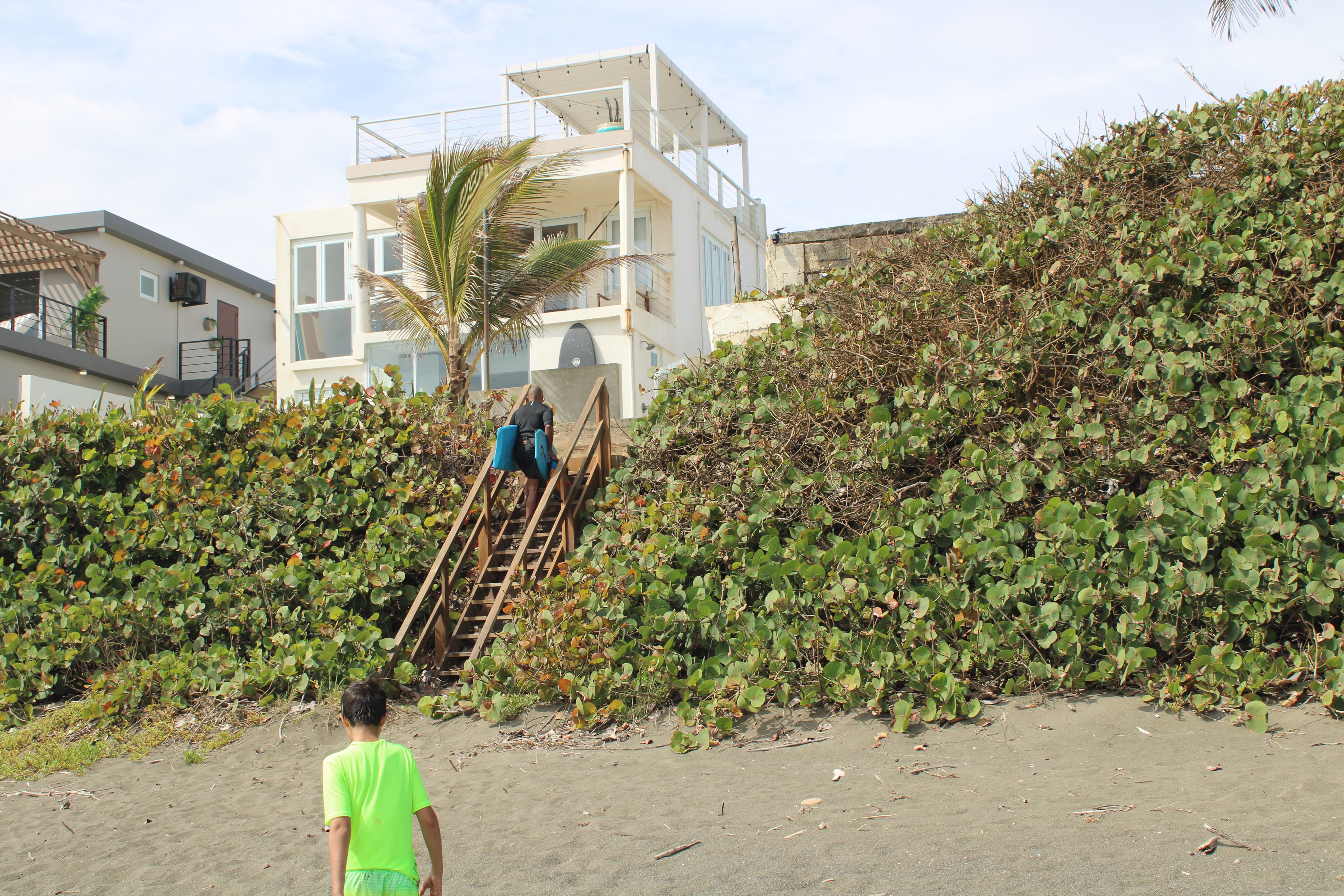 Walking up the beach stairs after catching waves behind Arenas Negra