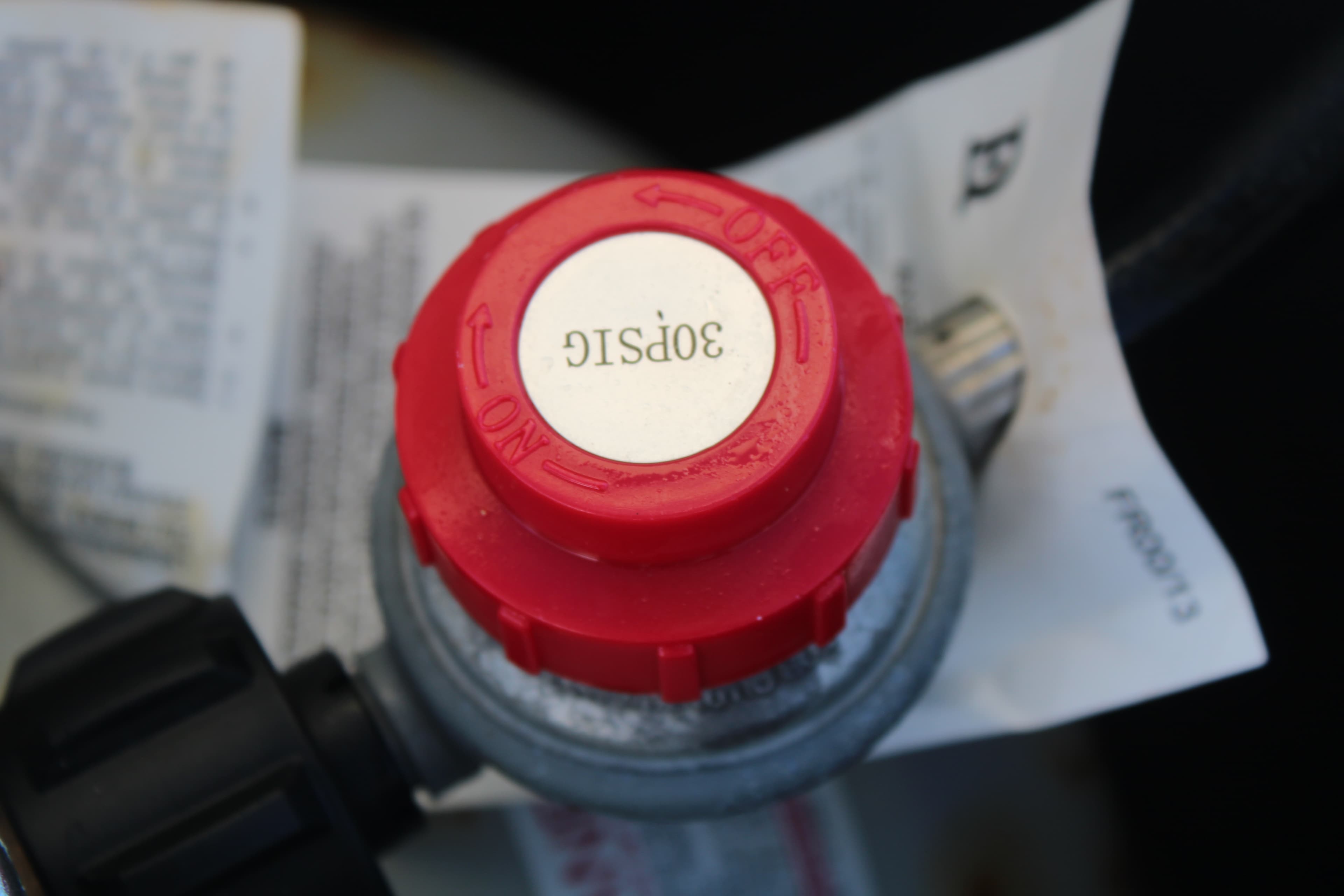 Red pressure regulator showing 30 PSIG