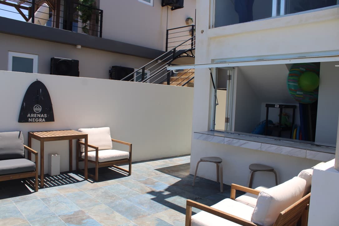 Poolside lounge chairs beside the open serving window and bar counter