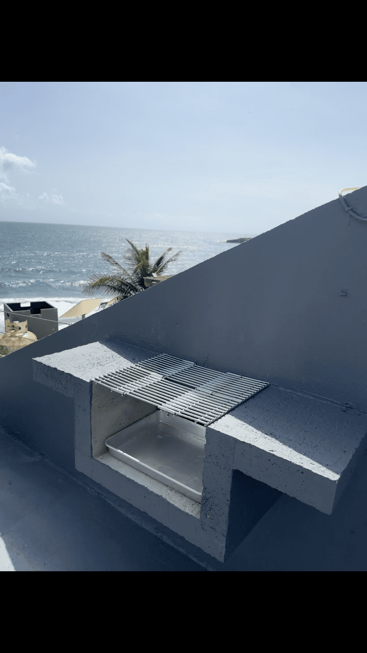 Rooftop BBQ grill with ocean views at Arenas Negra